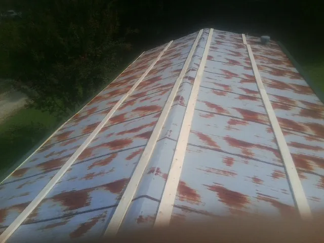 Rusted metal roof panels with new wood purlins before replacement — Storm Damage Roof Repair in Hansville by Roofing Brothers